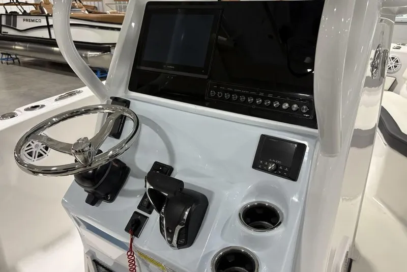 Slide: The Image of 2026 Tidewater 232 CC Adventure boat console with steering wheel and electronic controls. - 14
