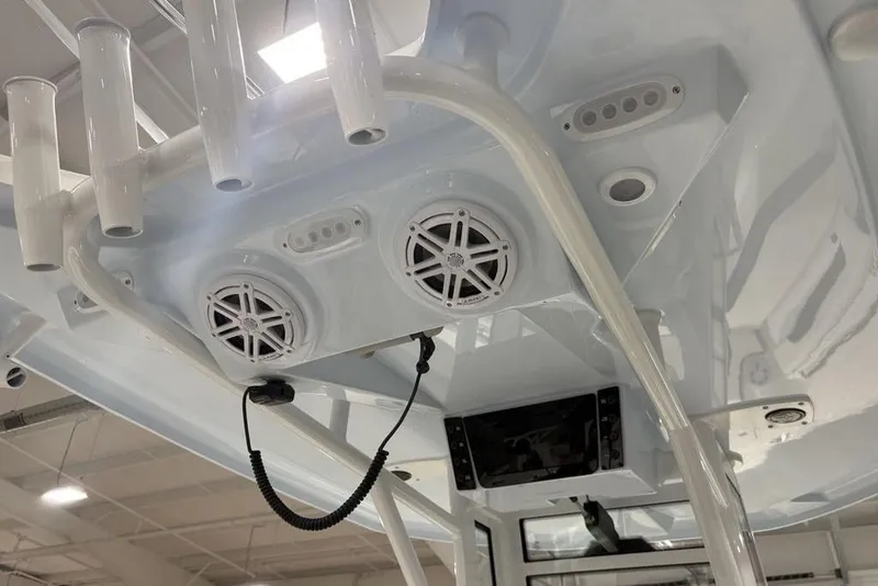 Slide: The Image of 2026 Tidewater 232 CC Adventure boat interior with speakers and rod holders. - 16