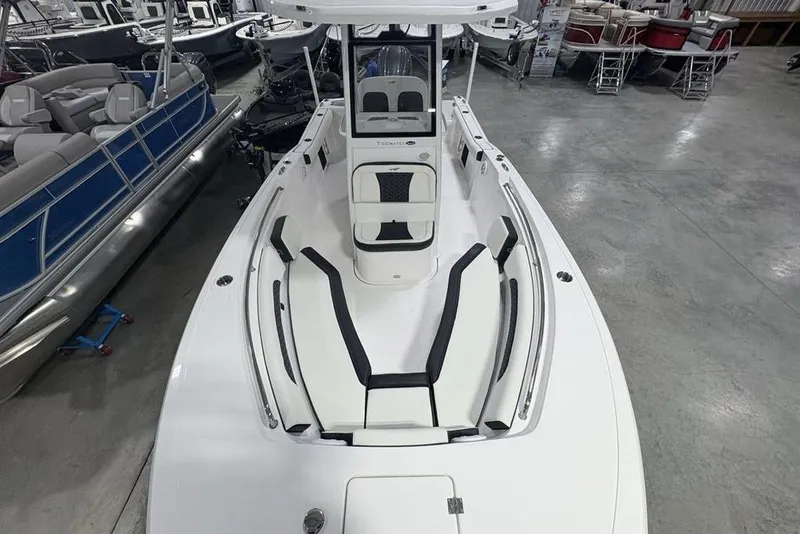 Slide: The Image of 2026 Tidewater 232 CC Adventure boat with sleek white design in showroom. - 20