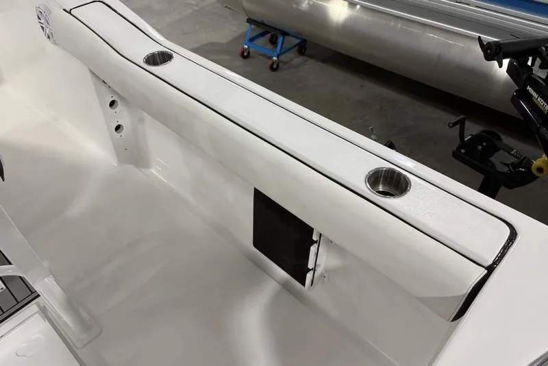 Slide: The Image of 2026 Tidewater 232 CC Adventure boat interior with cup holders and sleek design. - 21