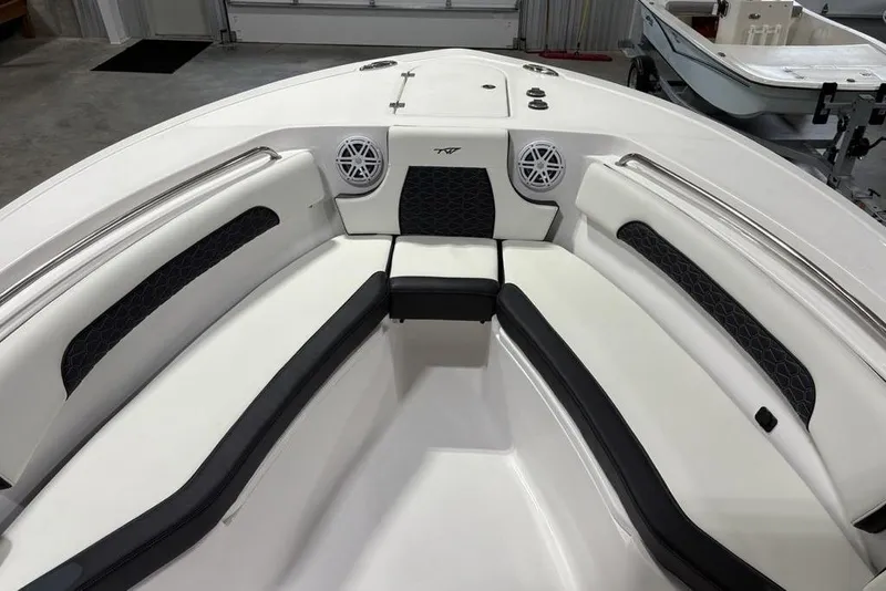 Slide: The Image of 2026 Tidewater 232 CC Adventure boat interior with cushioned seating and speakers. - 8