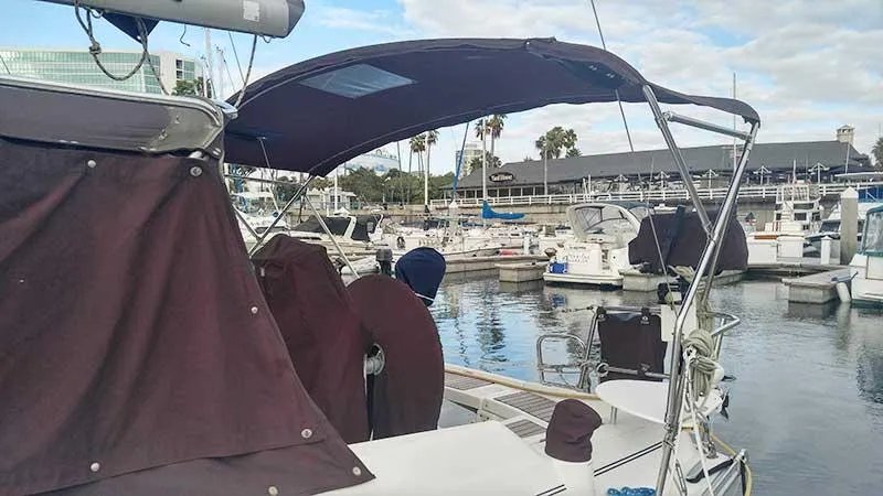 Slide: The Image of 2007 Beneteau 343 sailboat docked at marina with covered cockpit and clear sky. - 4