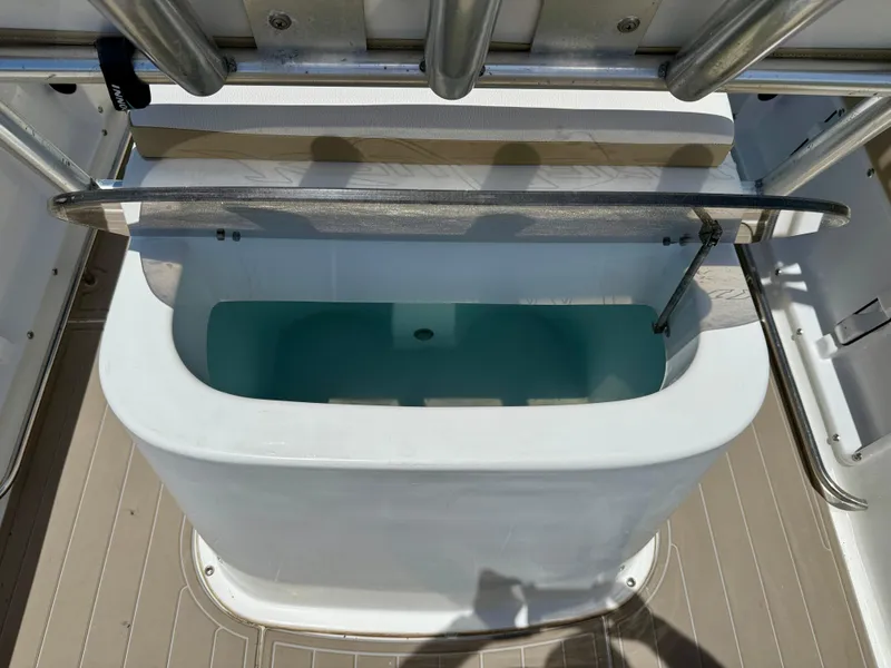 Slide: The Image of 2016 Key Largo 2100 WI CC boat seating area with cushioned seat and speaker. - 26