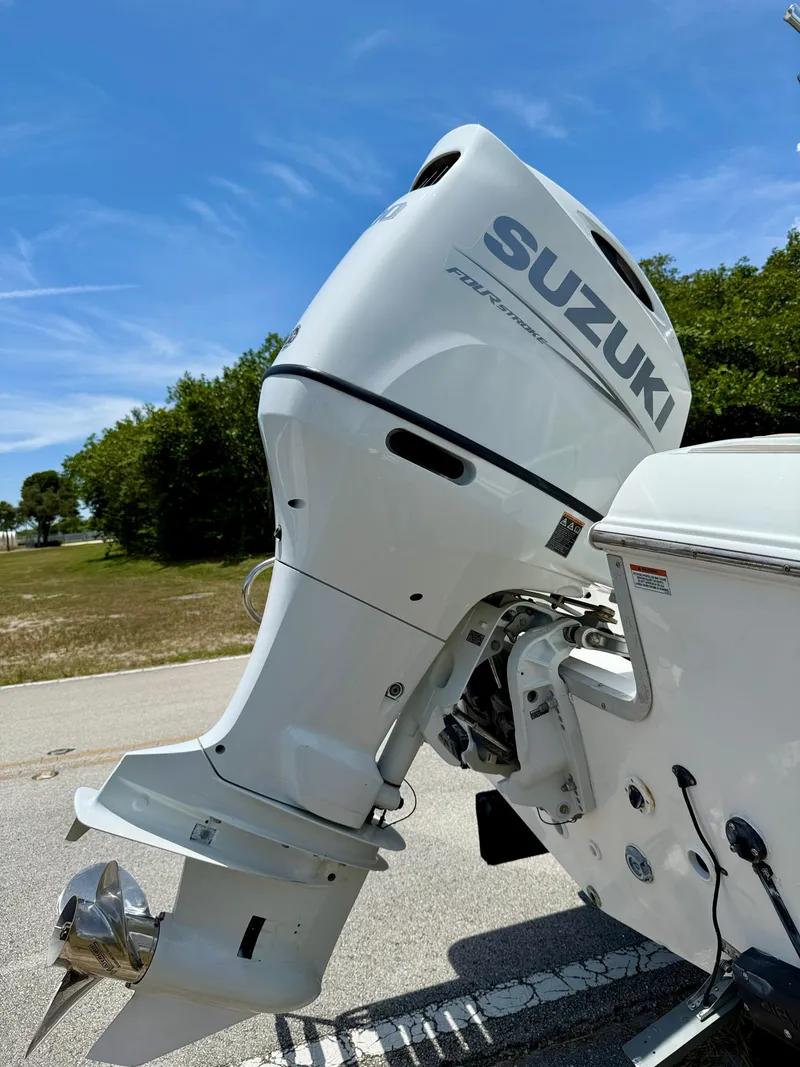 Slide: The Image of 2016 Key Largo 2100 WI CC boat hull on trailer, sunny day, trees in background. - 34