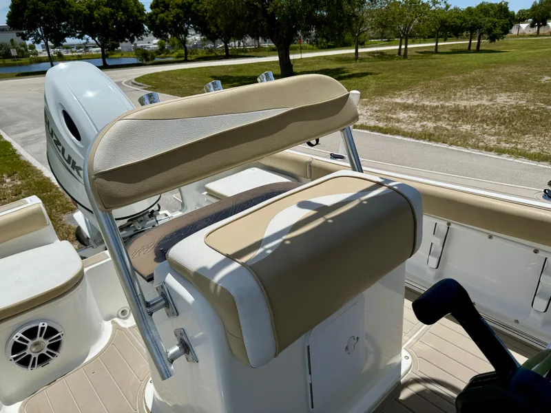 Slide: The Image of 2016 Key Largo 2100 WI CC boat interior with tan deck and speaker. - 9
