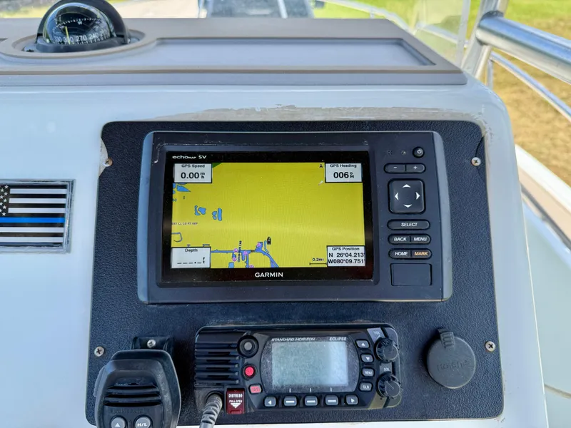 Slide: The Image of Garmin GPS and radio on 2016 Key Largo 2100 WI CC boat dashboard. - 12