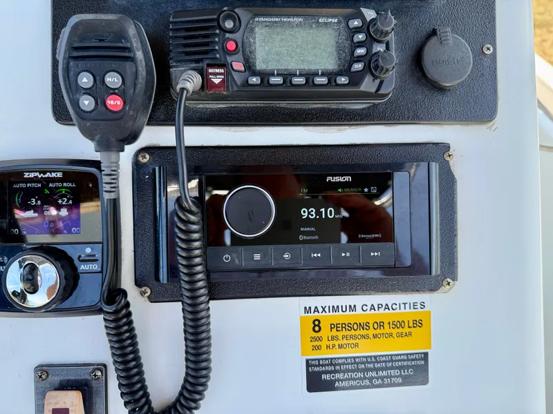 Slide: The Image of Boat dashboard with radio, controls, and capacity label on 2016 Key Largo 2100 WI CC. - 13