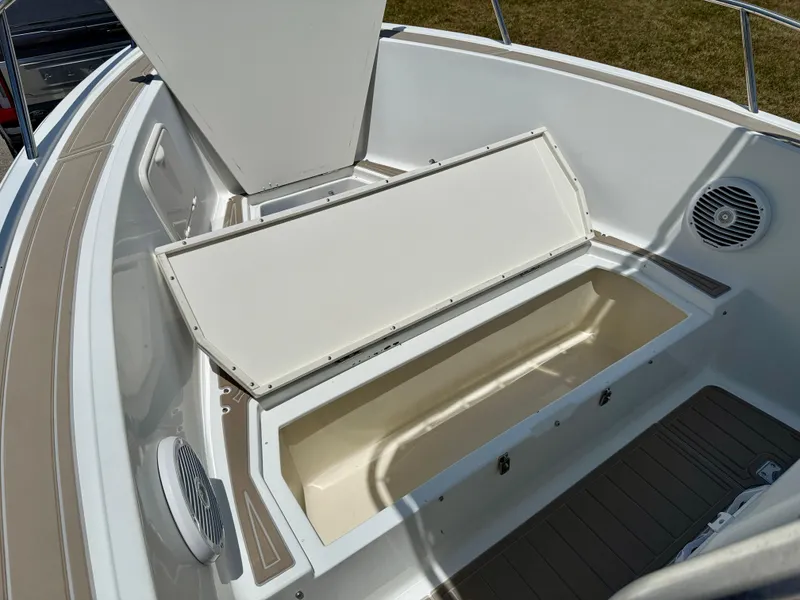 Slide: The Image of 2016 Key Largo 2100 WI CC boat storage compartment with open hatch and speaker. - 23