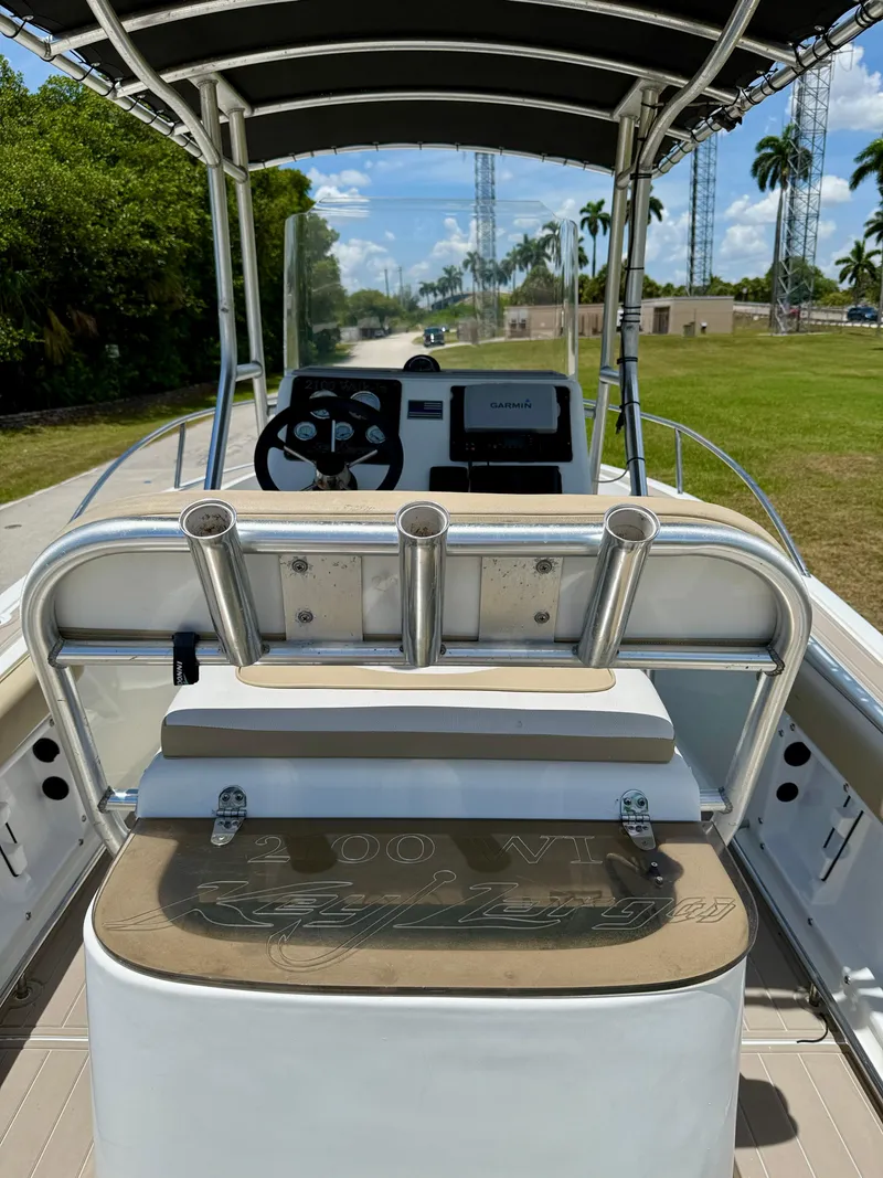 Slide: The Image of 2016 Key Largo 2100 WI CC boat interior with steering console and rod holders. - 25