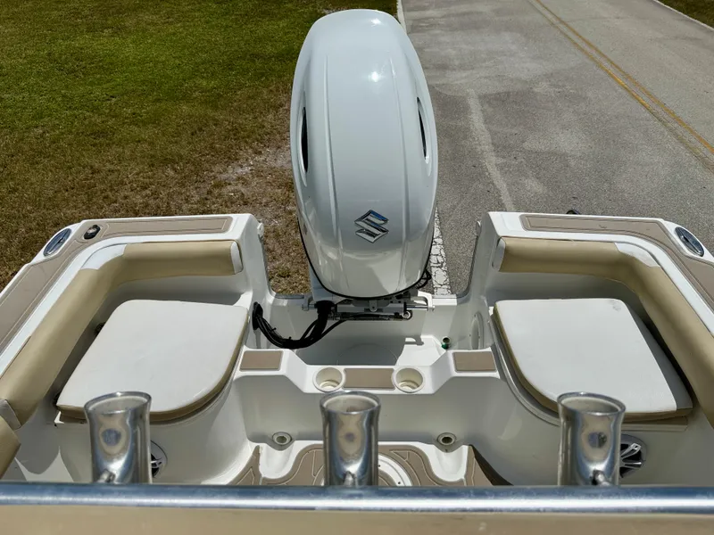 Slide: The Image of 2016 Key Largo 2100 WI CC boat with Suzuki outboard motor, rear seating, and rod holders. - 28