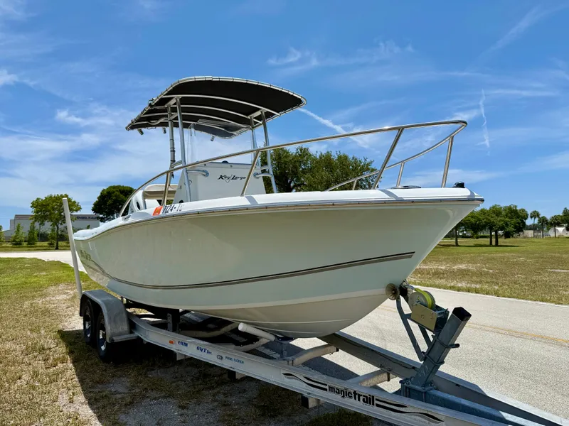 Slide: The Image of 2016 Key Largo 2100 WI CC boat on trailer under clear blue sky. - 3