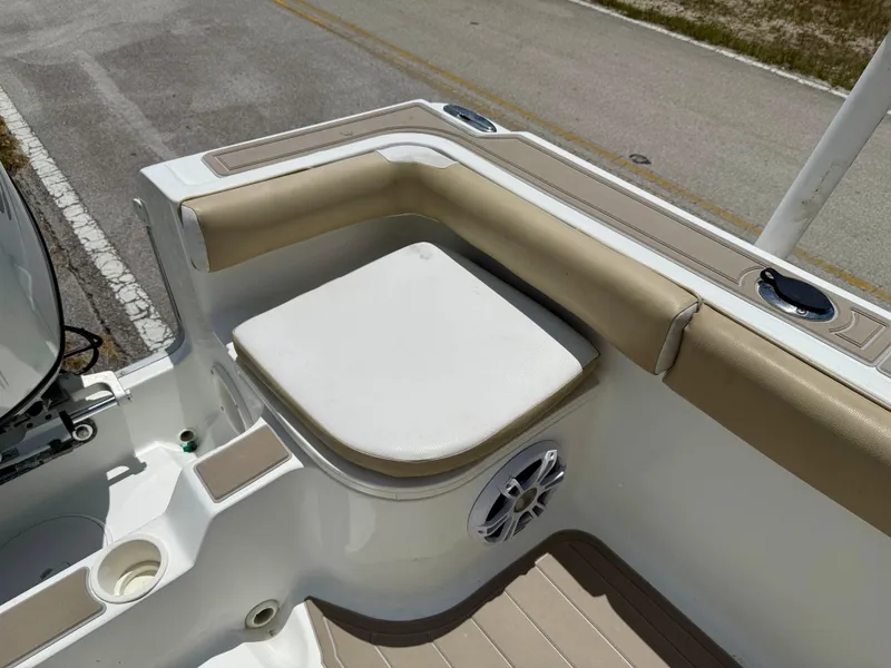 Slide: The Image of 2016 Key Largo 2100 WI CC boat seating area with cushioned seat and speaker. - 30