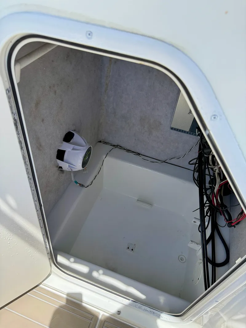 Slide: The Image of 2016 Key Largo 2100 WI CC boat storage compartment with wiring and speaker. - 31