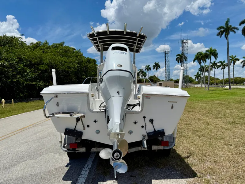 Slide: The Image of 2016 Key Largo 2100 WI CC boat on trailer, sunny day, palm trees in background. - 5