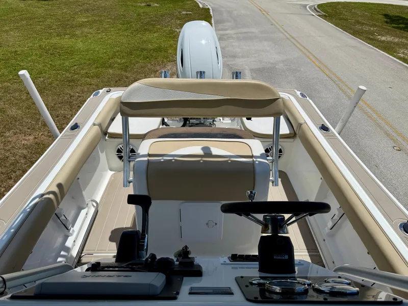 Slide: The Image of 2016 Key Largo 2100 WI CC boat interior with steering wheel and seating. - 7