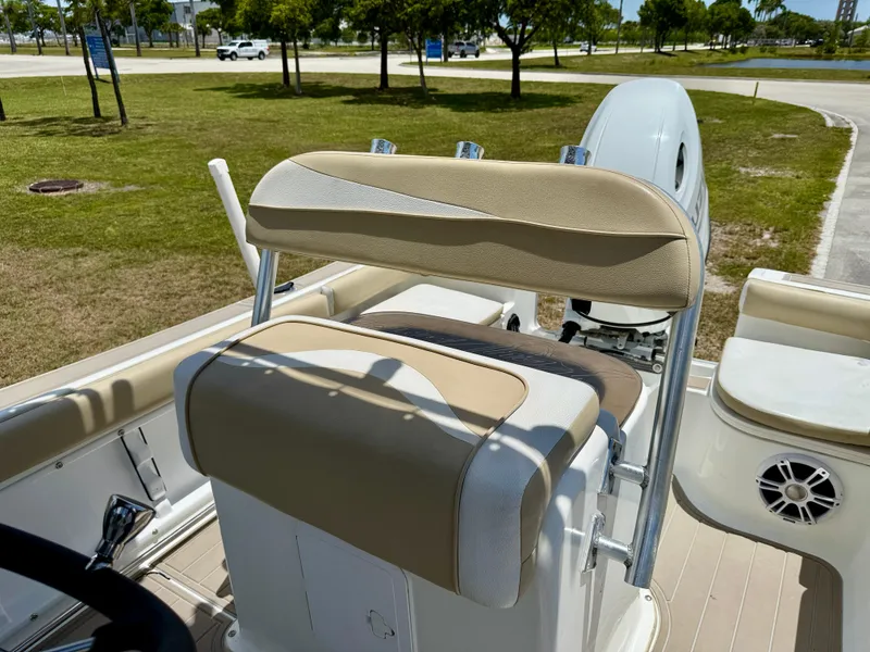 Slide: The Image of 2016 Key Largo 2100 WI CC boat interior with beige seating and steering wheel. - 8