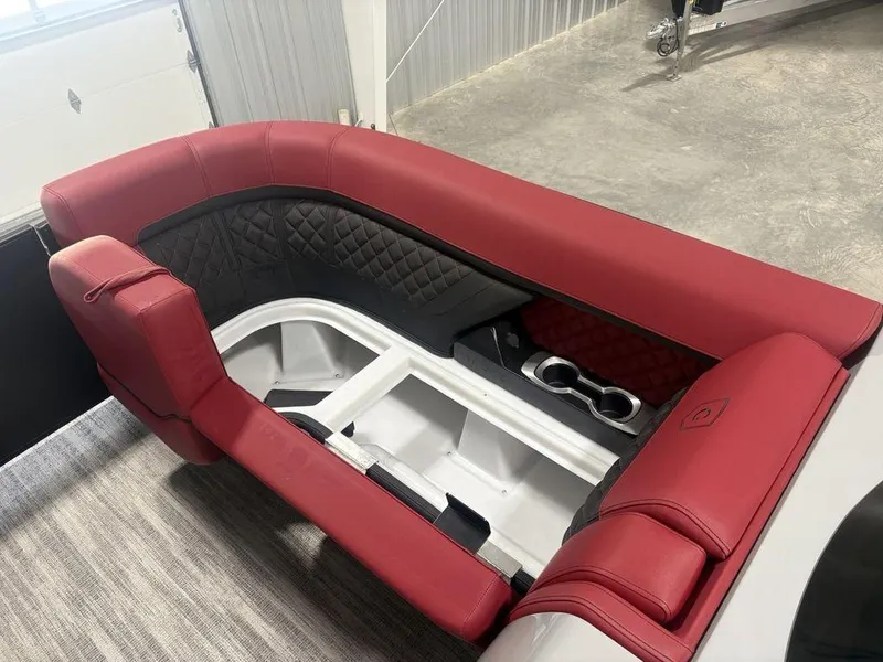 Slide: The Image of Red and black seating on 2025 Godfrey AquaPatio 235 DFLC boat, featuring cup holders. - 1