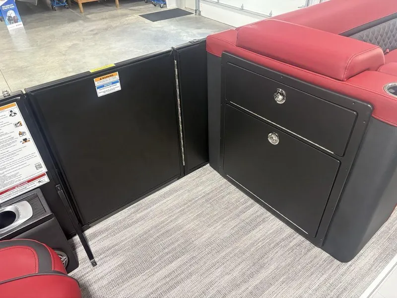 Slide: The Image of 2025 Godfrey AquaPatio 235 DFLC interior with red seating and storage compartments. - 10