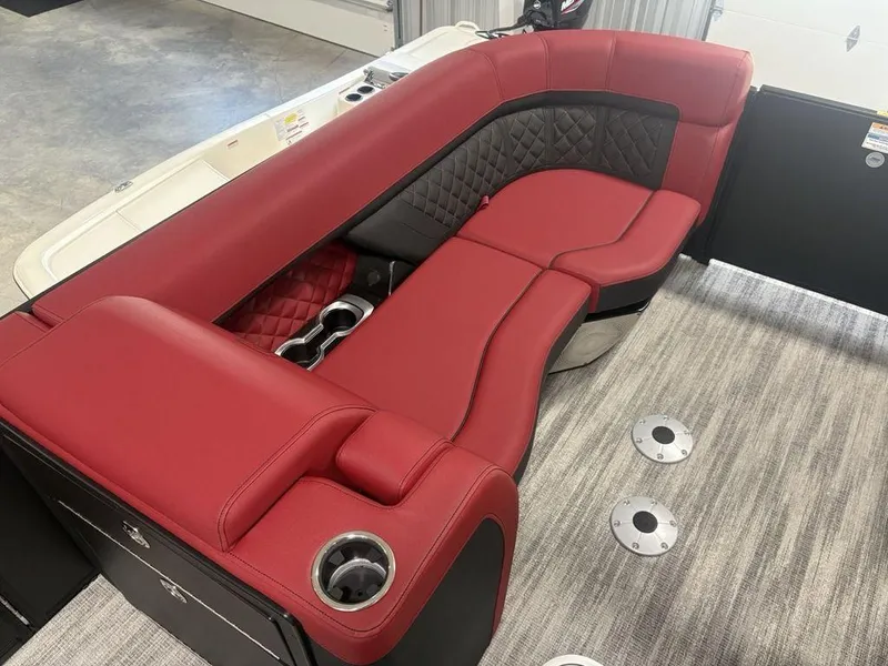 Slide: The Image of 2025 Godfrey AquaPatio 235 DFLC boat interior with red and black seating, cup holders. - 13