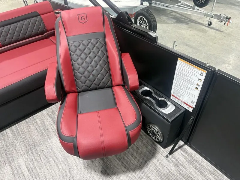 Slide: The Image of Luxurious red and black seating on 2025 Godfrey AquaPatio 235 DFLC boat, featuring cup holders. - 15