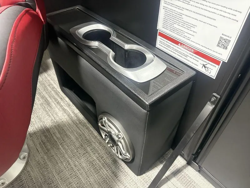 Slide: The Image of Cup holders and speaker on 2025 Godfrey AquaPatio 235 DFLC iMPACT boat interior. - 16