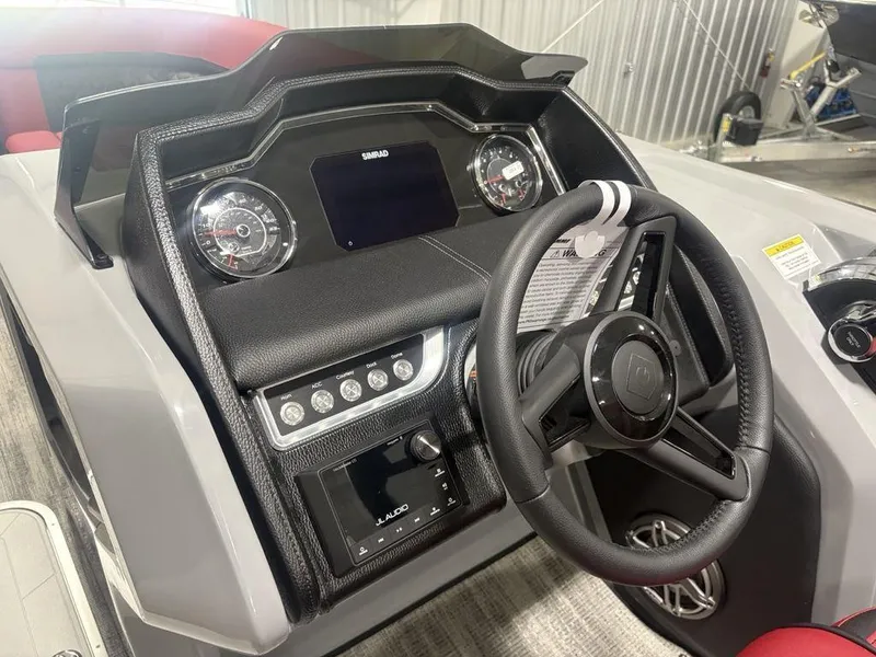 Slide: The Image of 2025 Godfrey AquaPatio 235 DFLC dashboard with steering wheel and control panel. - 18