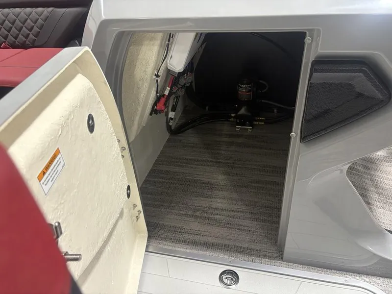 Slide: The Image of Open storage compartment on 2025 Godfrey AquaPatio 235 DFLC iMPACT pontoon boat. - 19