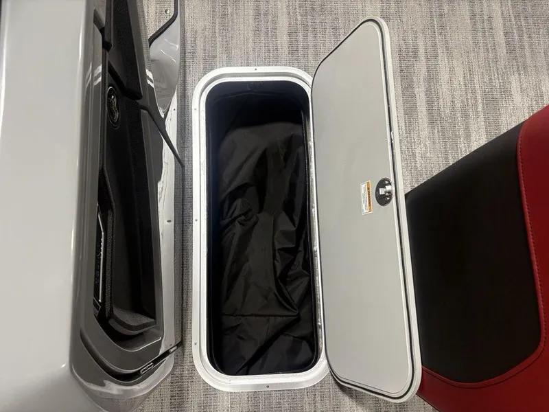 Slide: The Image of Open storage compartment on 2025 Godfrey AquaPatio 235 DFLC iMPACT pontoon boat. - 22