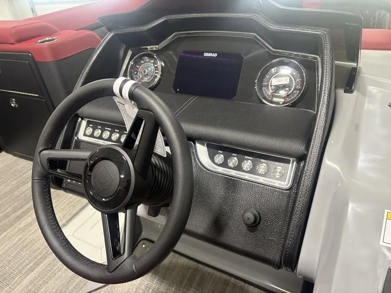 Slide: The Image of 2025 Godfrey AquaPatio 235 DFLC dashboard with steering wheel and control panel. - 23