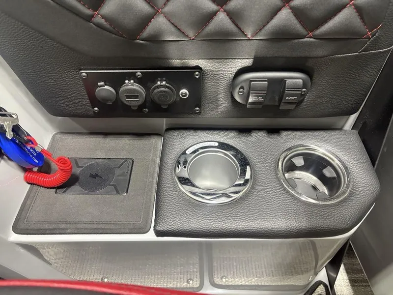 Slide: The Image of Control panel and cup holders on 2025 Godfrey AquaPatio 235 DFLC iMPACT boat. - 24