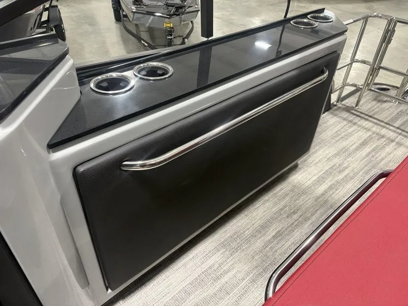 Slide: The Image of 2025 Godfrey AquaPatio 235 DFLC boat interior with cup holders and sleek design. - 29