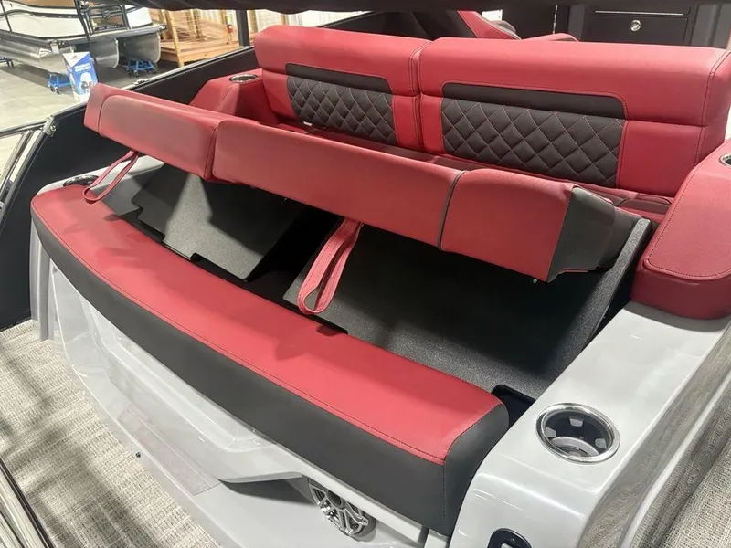 Slide: The Image of Red and black seating on 2025 Godfrey AquaPatio 235 DFLC boat, featuring cup holders. - 34