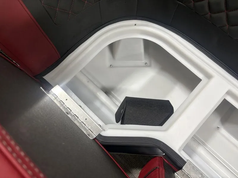 Slide: The Image of Interior storage compartment of 2025 Godfrey AquaPatio 235 DFLC boat, featuring red and black upholstery. - 6