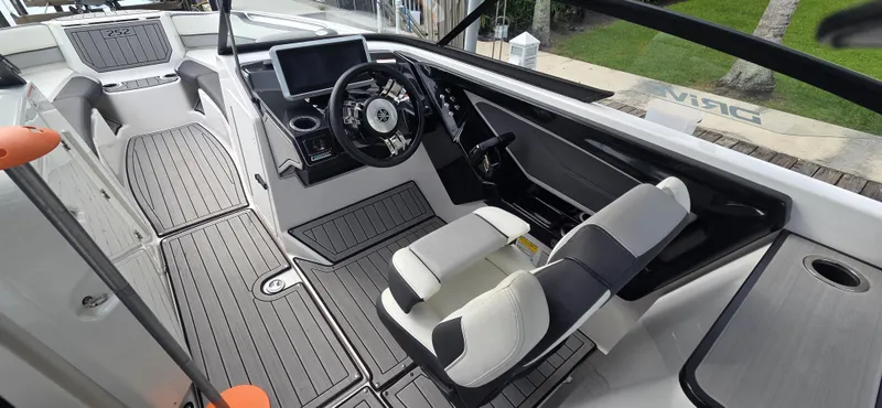 Slide: The Image of 2023 Yamaha Boats 252SD interior with modern helm, touchscreen, and sleek seating. - 16