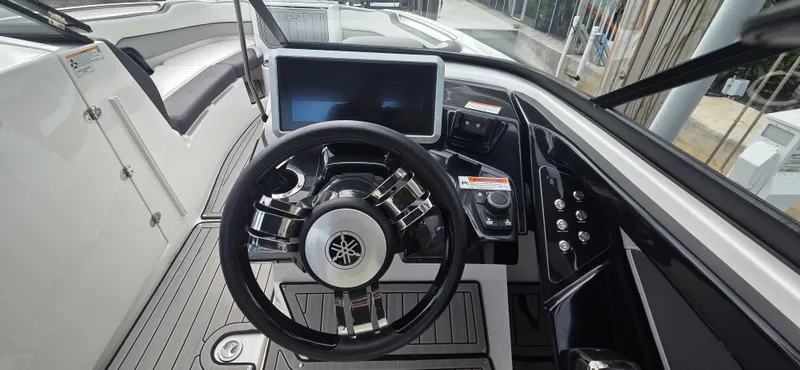 Slide: The Image of 2023 Yamaha Boats 252SD dashboard with steering wheel and touchscreen display. - 17