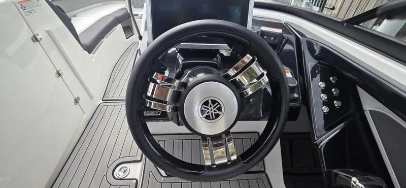 Slide: The Image of Steering wheel of 2023 Yamaha Boats 252SD, featuring sleek design and modern controls. - 19