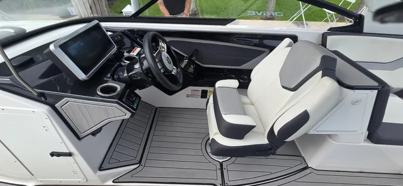 Slide: The Image of 2023 Yamaha Boats 252SD cockpit with modern steering, touchscreen, and comfortable seating. - 20