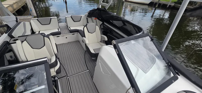 Slide: The Image of 2023 Yamaha Boats 252SD interior with sleek seating and modern design on the water. - 22