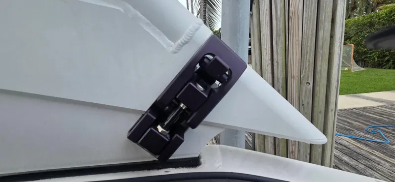 Slide: The Image of Close-up of a 2023 Yamaha Boats 252SD hinge detail on a dock. - 24