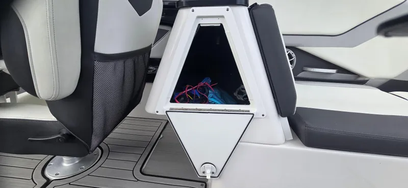 Slide: The Image of 2023 Yamaha Boats 252SD interior storage compartment with seating and accessories. - 26