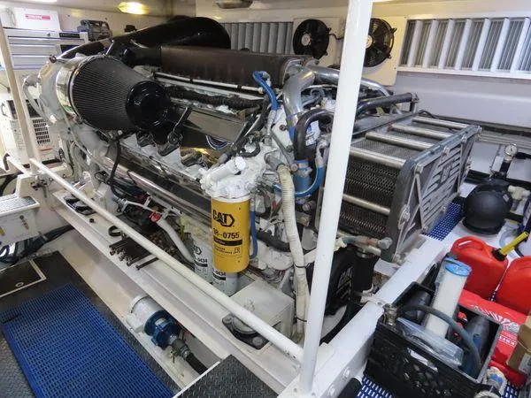 Slide: The Image of Engine room of a 2009 Viking 64 Convertible yacht, showcasing detailed machinery and components. - 12