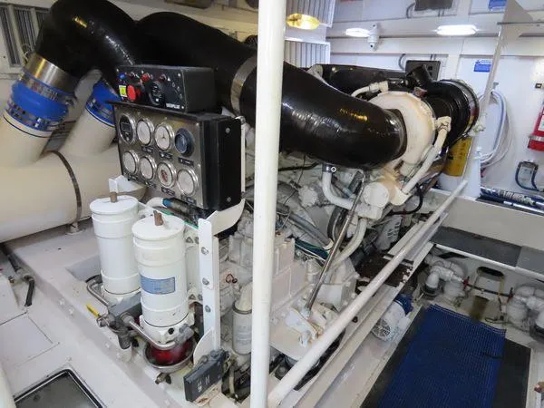 Slide: The Image of Engine room of 2009 Viking 64 Convertible yacht, showcasing complex machinery and components. - 13