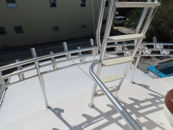 Slide: The Image of 2009 Viking 64 Convertible yacht deck with metal railings and ladder. - 18