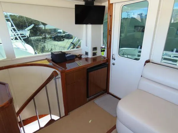 Slide: The Image of Interior of 2009 Viking 64 Convertible yacht with seating, TV, and staircase. - 21