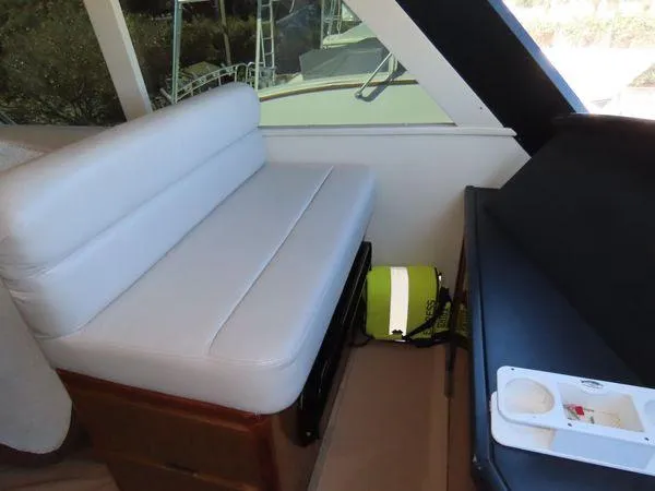 Slide: The Image of 2009 Viking 64 Convertible yacht interior with seating and storage area. - 22
