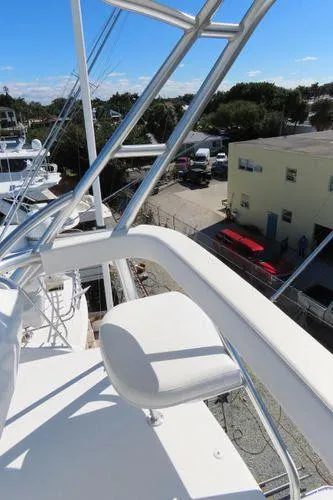 Slide: The Image of 2009 Viking 64 Convertible yacht, view from upper deck with clear skies. - 23