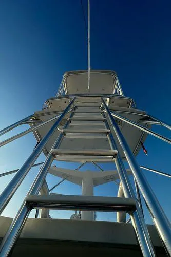 Slide: The Image of Ladder view on 2009 Viking 64 Convertible yacht against clear blue sky. - 25
