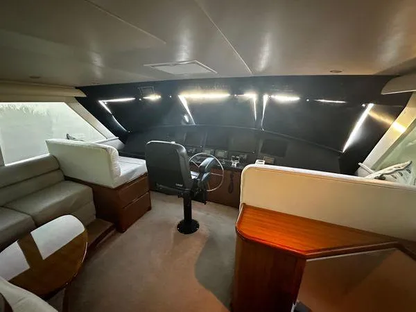 Slide: The Image of Interior of 2009 Viking 64 Convertible yacht, featuring helm and seating area. - 28