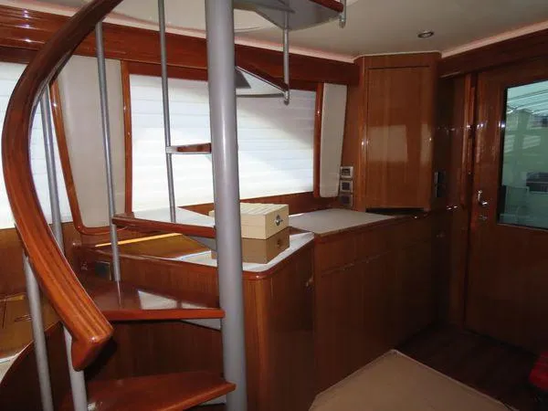 Slide: The Image of Interior of 2009 Viking 64 Convertible yacht with wooden spiral staircase. - 29