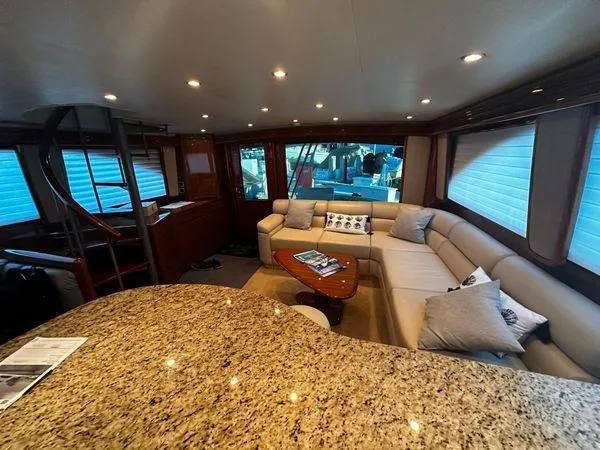 Slide: The Image of Luxurious interior of a 2009 Viking 64 Convertible yacht with plush seating and elegant decor. - 31